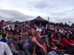 Afghans enjoying live music at cultural festival.