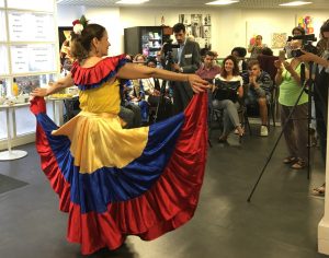 A migrant participant performs Columbian traditional dance.