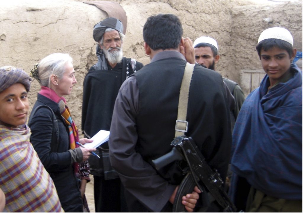 Lynne O'Donnell interviewing people in Helmand, Afghanistan, displaced by the US-led operation to clear Taliban from Marjah. Photo Credit to Behrouz Mehri.