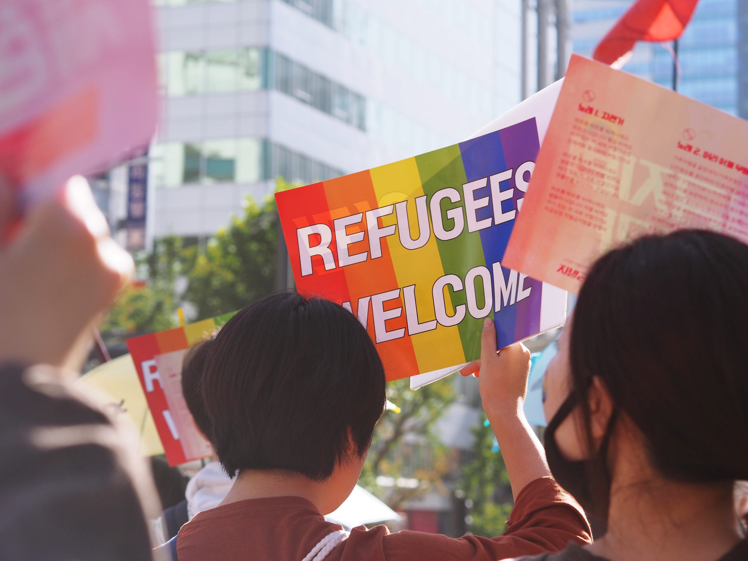 Image in street of refugee welcome sign