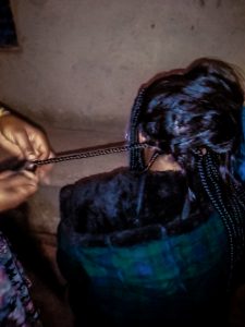 Woman having hair braided