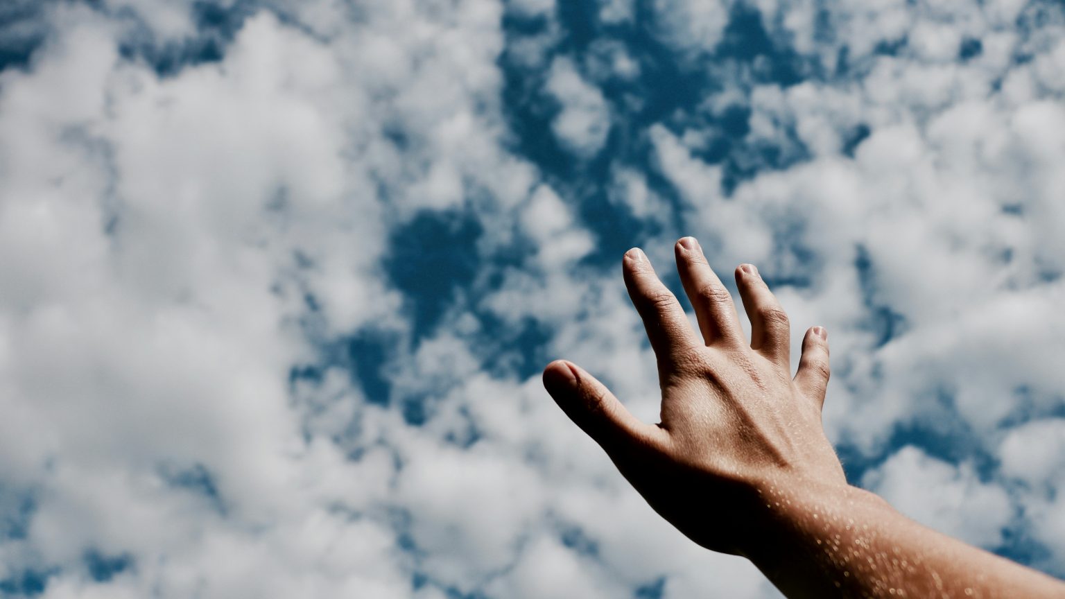 Hand reaching for sky