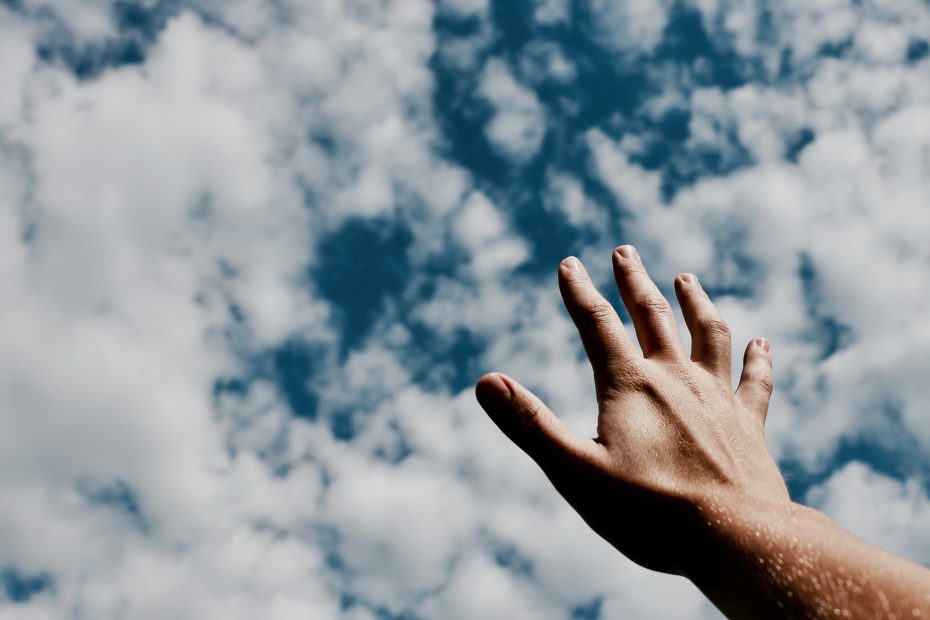 Hand reaching for sky